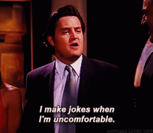 A GIF of Matthew Perry as Chandler, shaking someone's hand in a suit while saying "I make jokes when I'm uncomfortable"