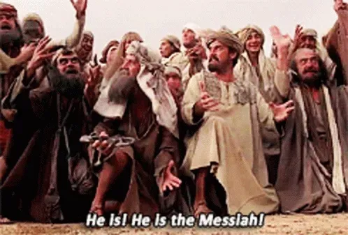 GIF from Monty Python's "Life of Brian" with a crowd of people screaming "he is! He is the messiah!" And bowing.